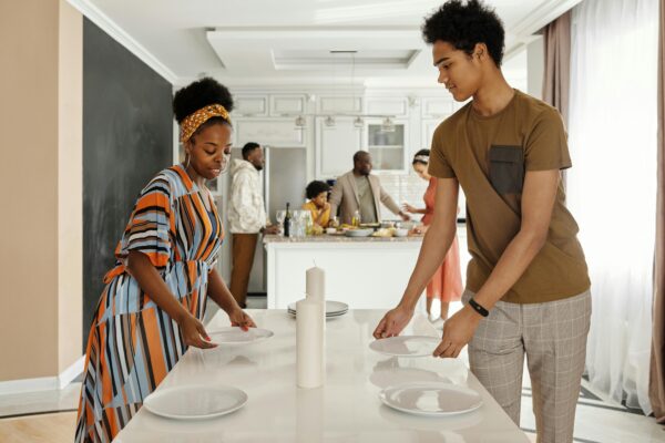 Mother and child in a clean kitchen environment promoting summer sanitization and healthy childcare practices.