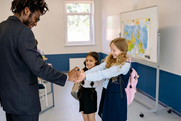 Teacher demonstrating use of a sanitizing cabinet in a classroom setting