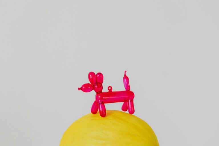 Plastic toy animals on a yellow surface, symbolizing the need for Sanitizing shared classroom items.
